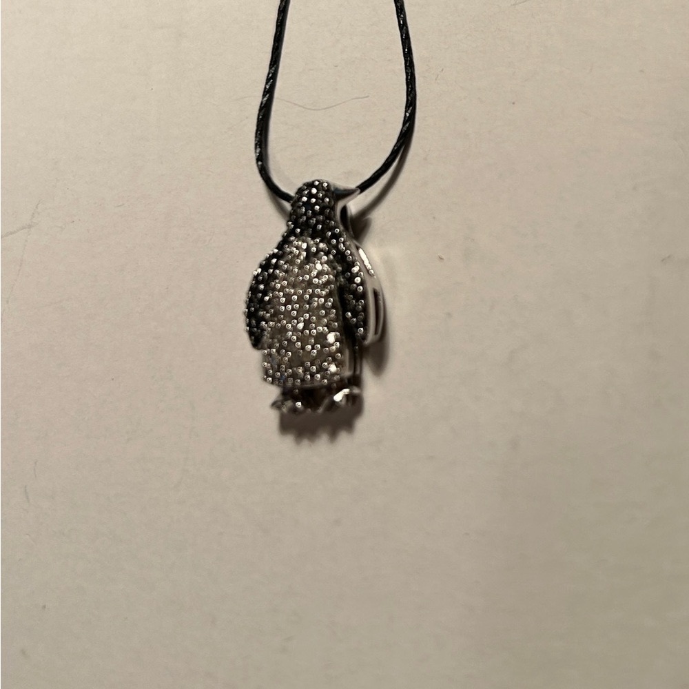 Penguin pendant in 925 with black and white diamonds. 925 silver black chain.